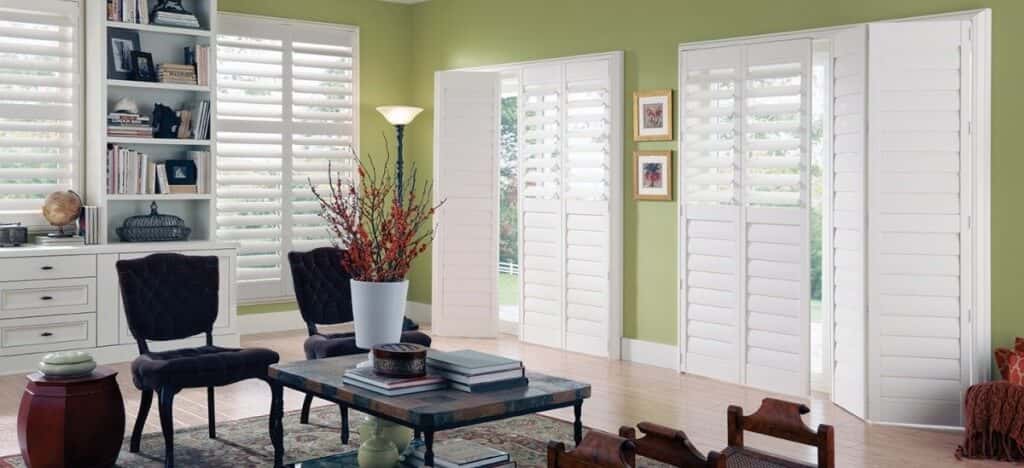 White shutters in a office with green walls