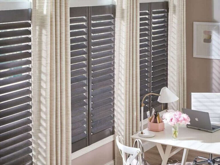 Full-height shutters are a versatile option that works beautifully when layered with curtains.