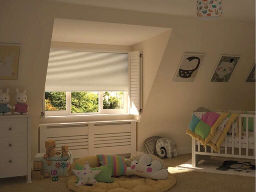 Blackout shades for nursery windows create a dark, cozy space that encourages deeper sleep.