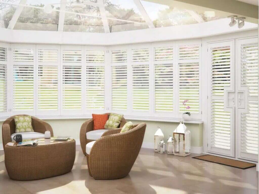 Shutters in a sunroom in a white house